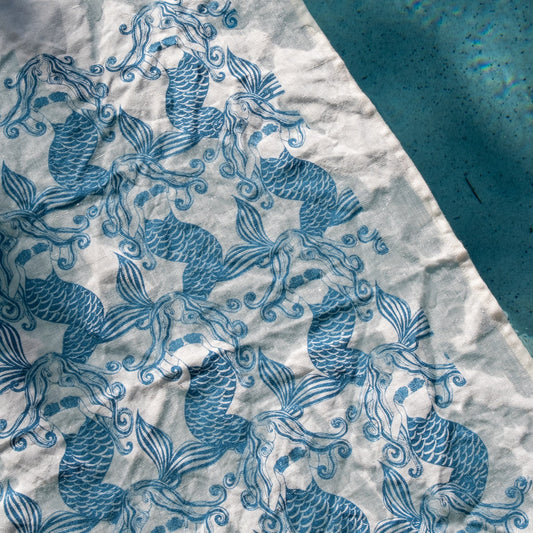 Mermaids Blue pure linen tea towel featuring Jess Scott’s repeating blue mermaid design