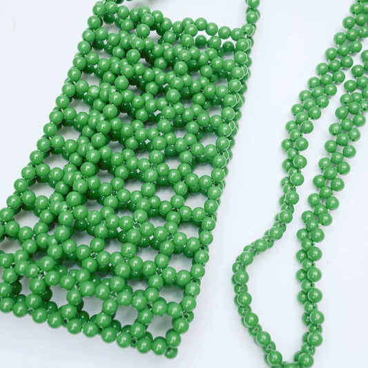 Green bead necklace on a white background