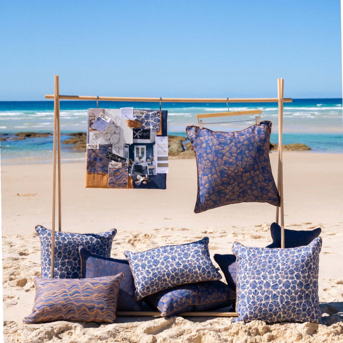 Mariner linen cushion collection styled on the beach with Pipi and coordinating blue and ochre cushion covers