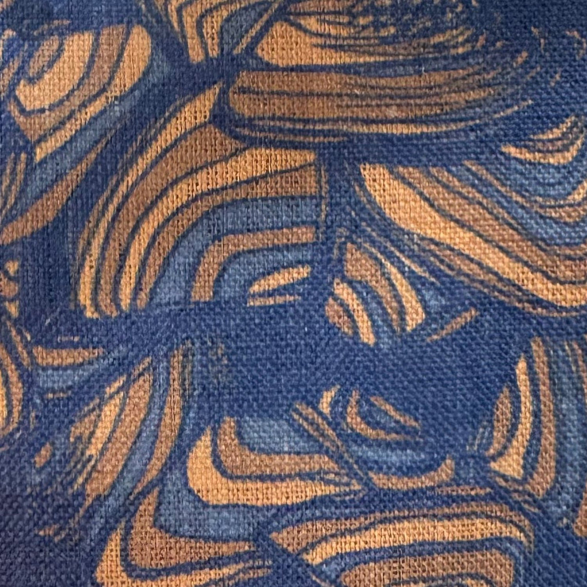 Close-up of Mariner Pipi linen fabric showing the navy and ochre printed pattern