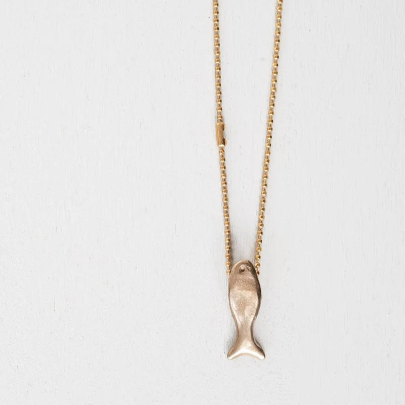 Bronze chain necklace with a fish pendant on a light gray background