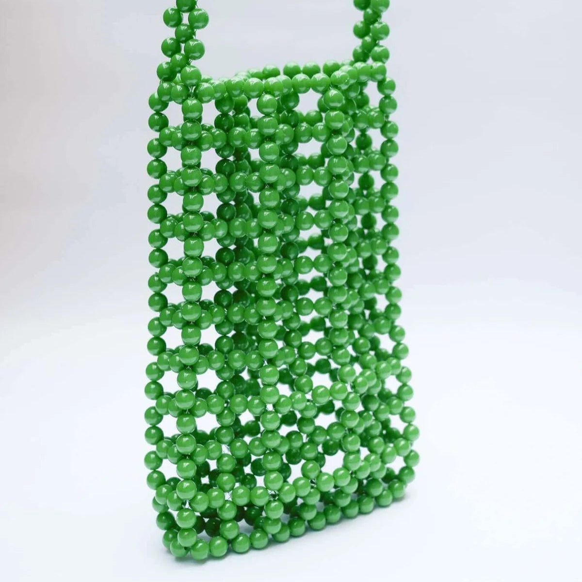 Green beaded bag on a white background