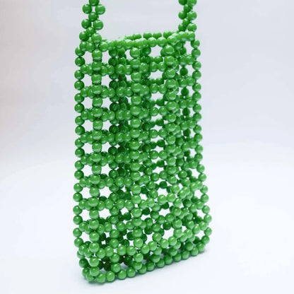 Green beaded bag on a white background