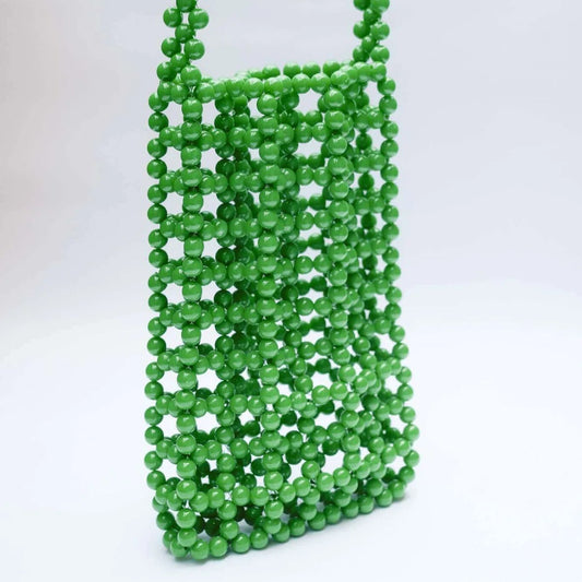 Green beaded bag on a white background