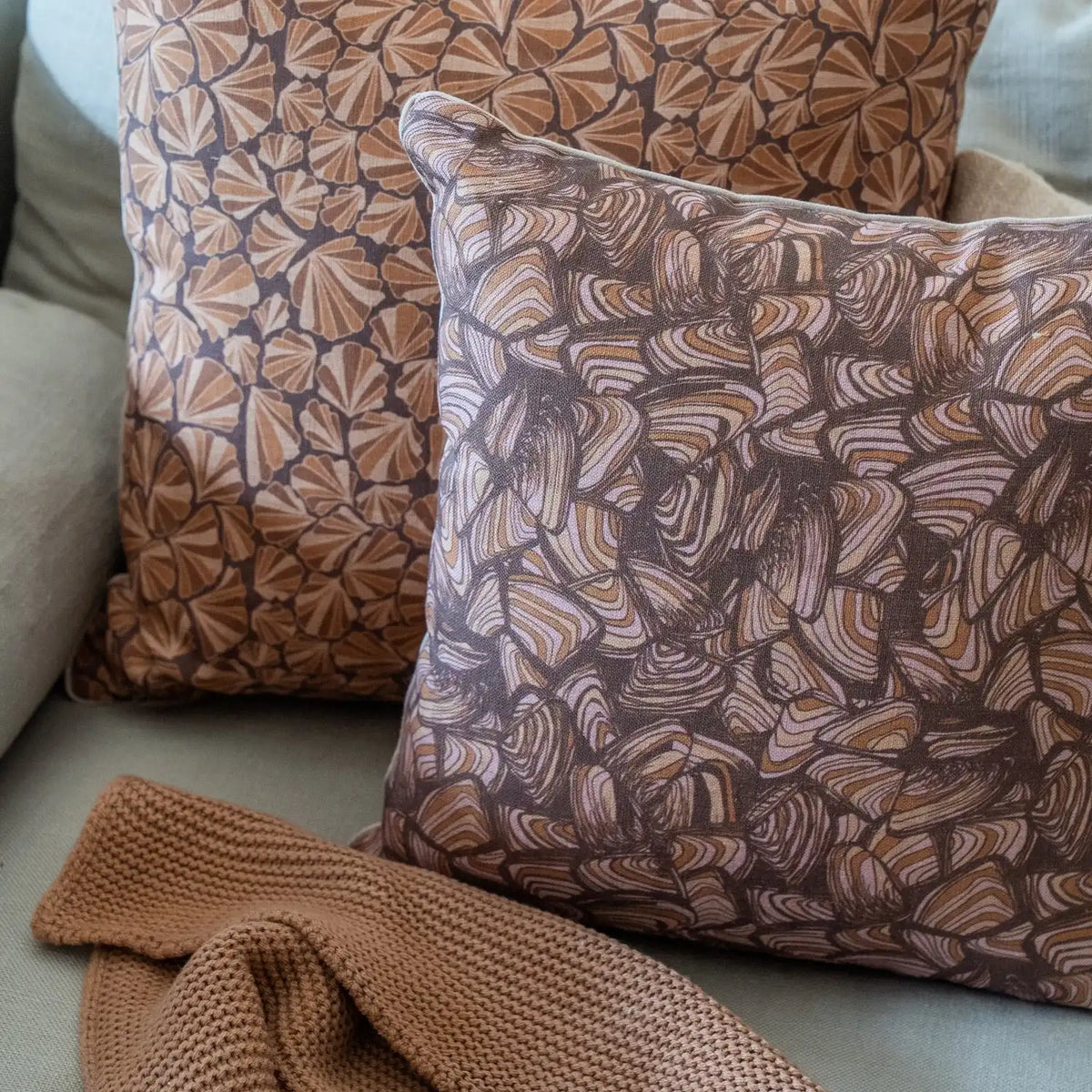 Claytons Pipi linen cushion cover styled on a lounge with matching Claytons Shells cushion