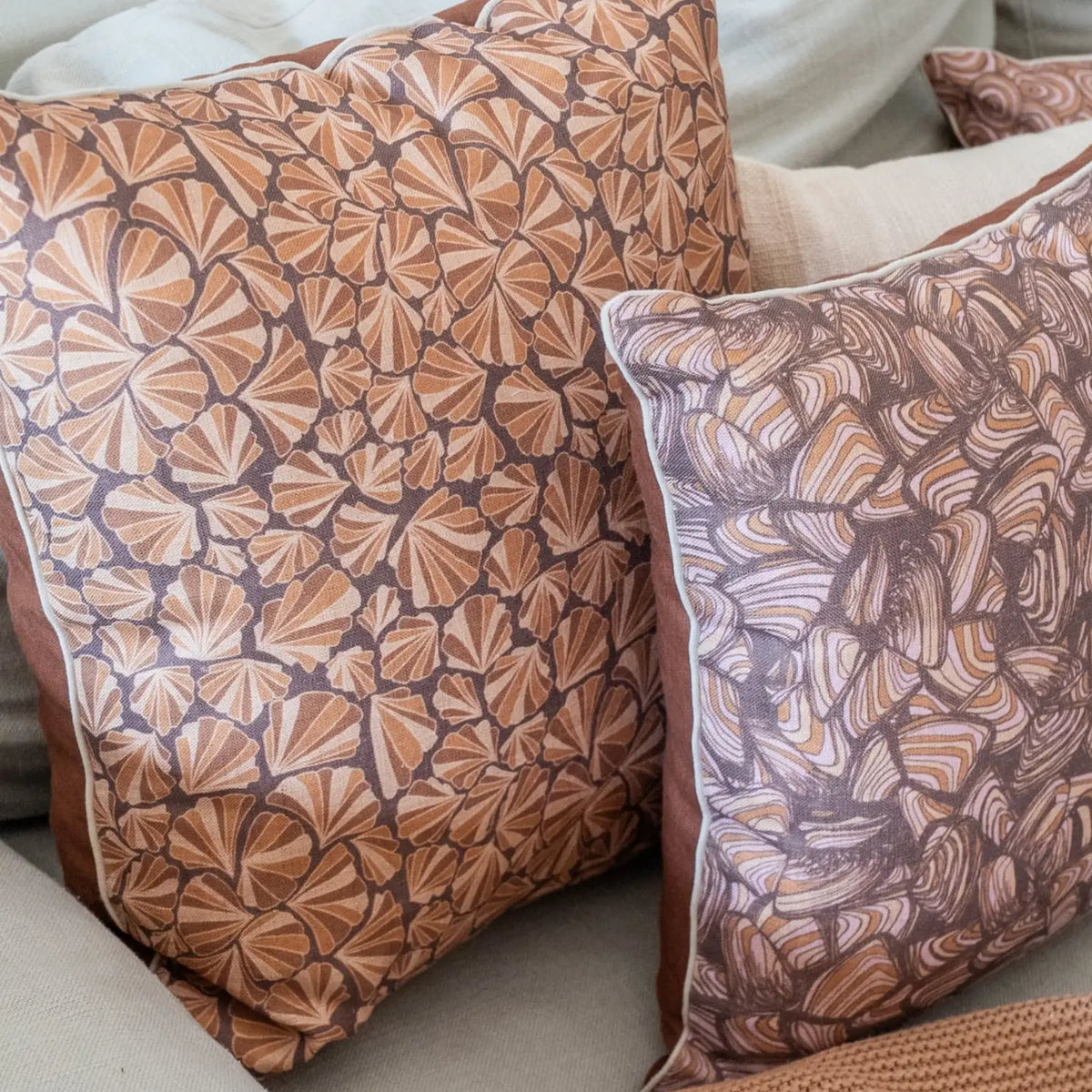 Claytons Shells linen cushion cover styled on a lounge with matching Claytons Pipi cushion