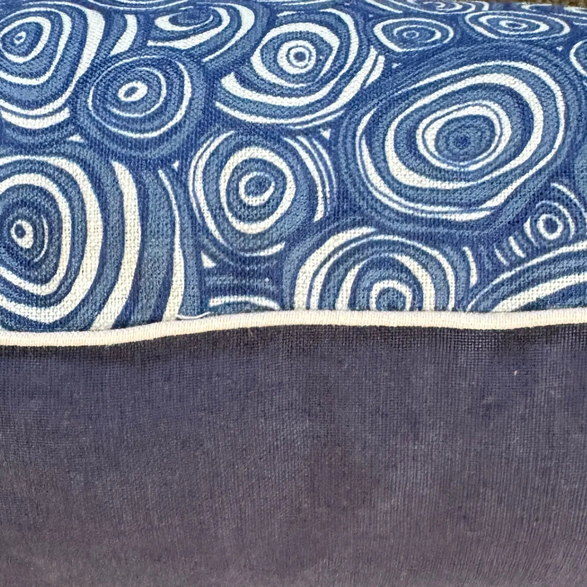 Close-up of Pacific Growth Rings linen fabric with natural piping and navy linen reverse