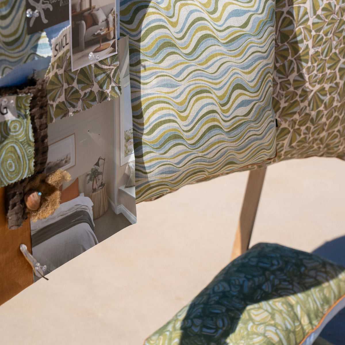 Straddie Stripe linen cushion cover displayed with Mangrove fabric swatches and coastal styling board