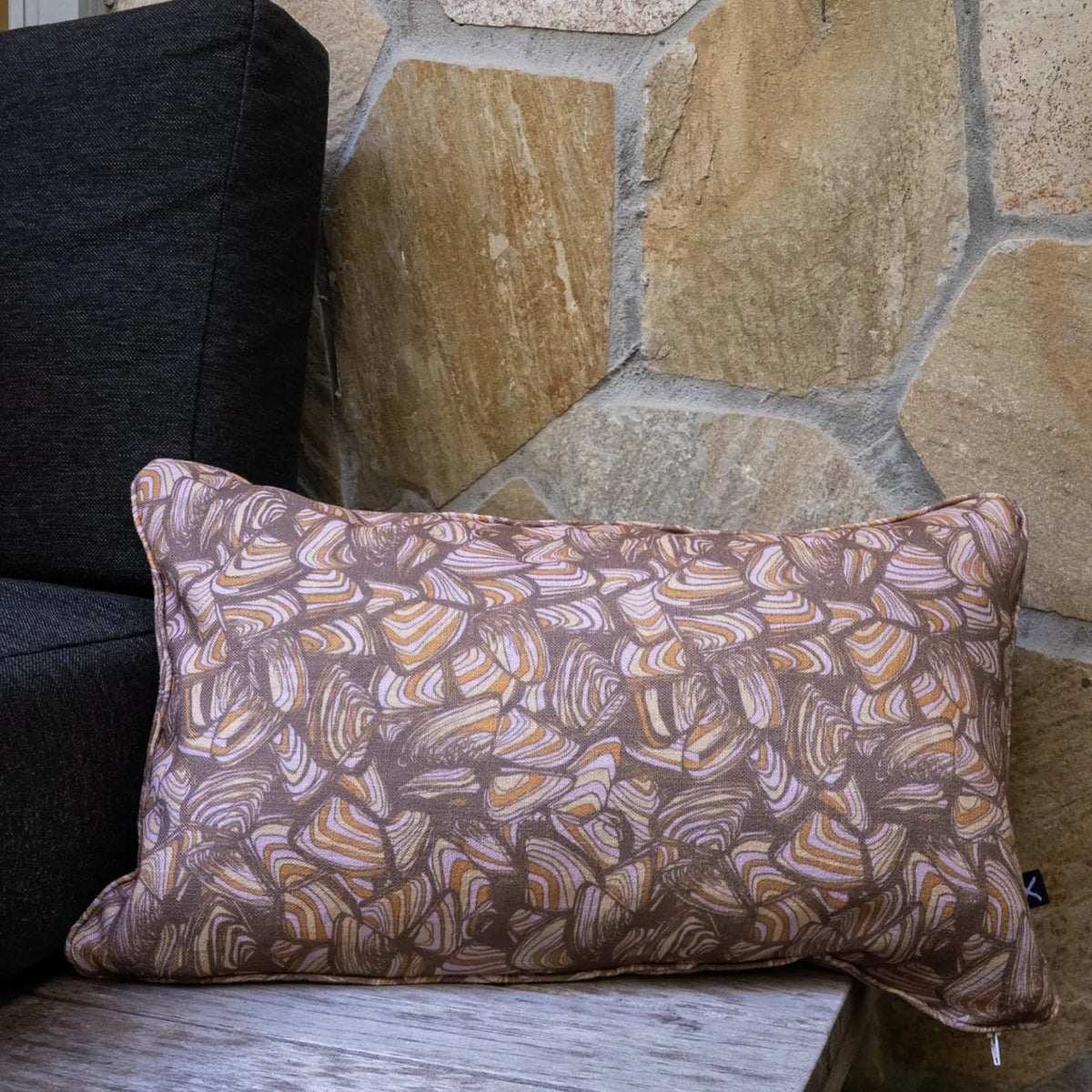 Claytons Pipi outdoor indoor cushion cover in a rectangular lumbar size styled on an outdoor chair.