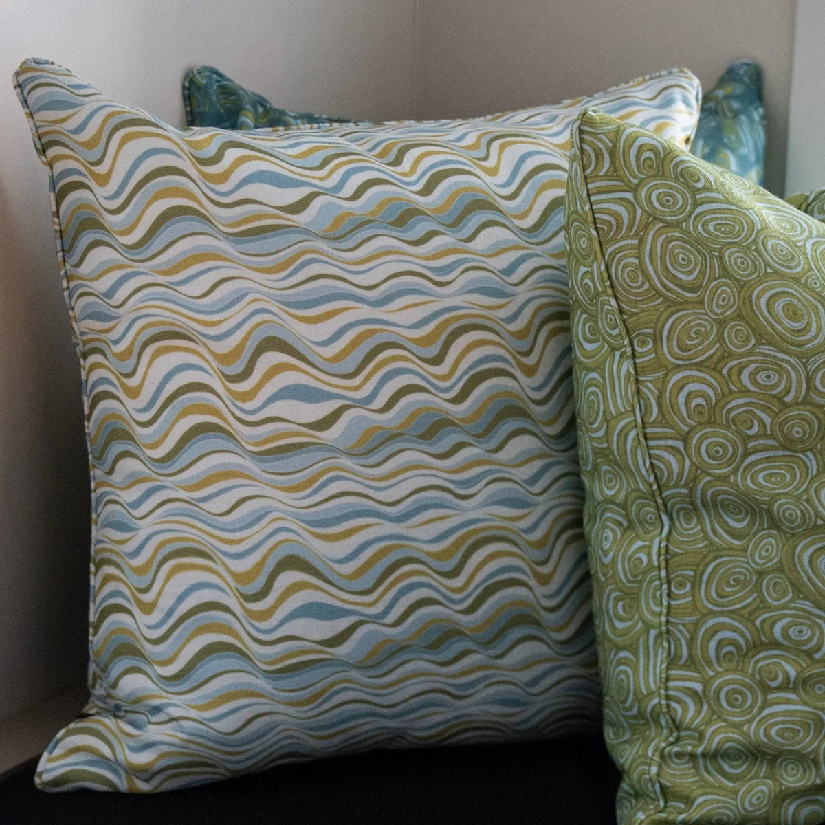 Mangrove Straddie Stripe outdoor indoor cushion cover shown close up beside a coordinating Growth Rings cushion.