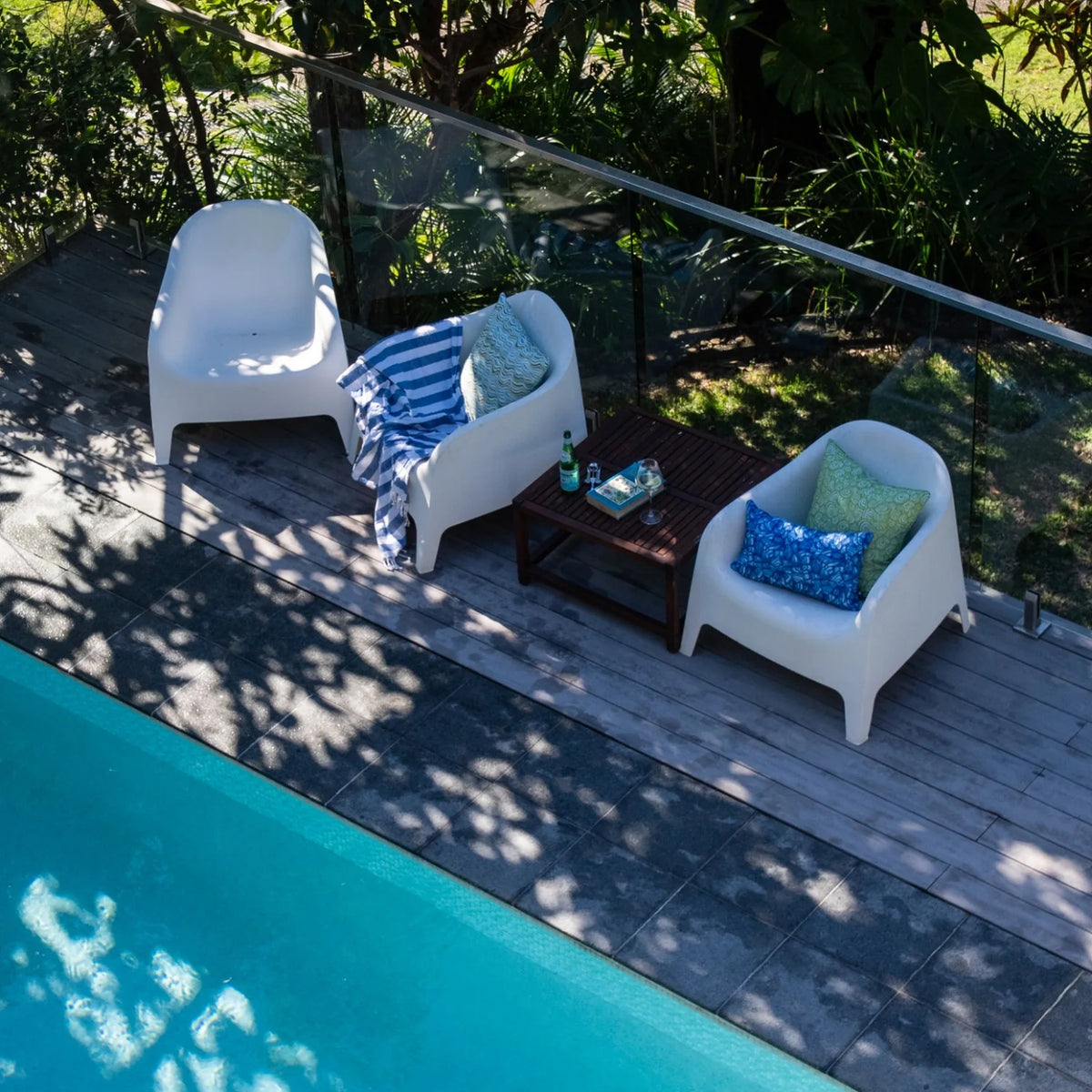 Ocean Growth Rings outdoor indoor cushion cover styled with a coordinating blue print cushion on a neutral sofa.